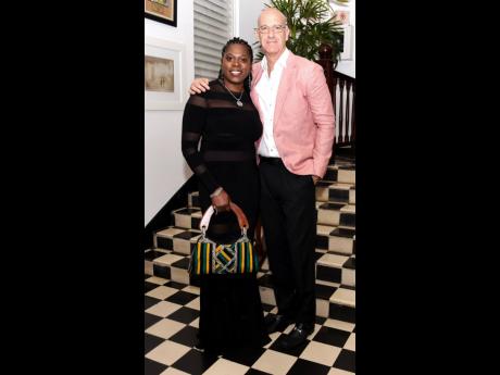 Paula Kovinsky embraces the ‘Jamaica Land We Love’ theme with her handbag, smiling brightly beside her husband, Mark.