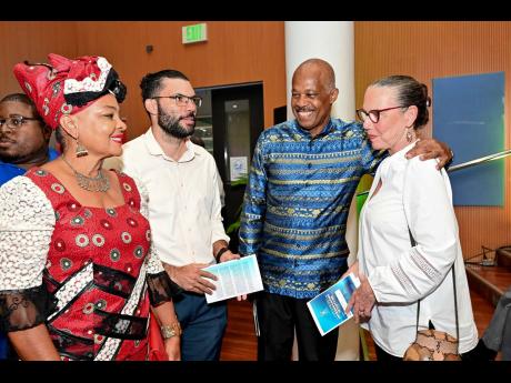 Lady Mary Beckles (left) with her husband, Professor Sir Hilary Beckles (third from left), Vice Chancellor of The University of the West Indies, with relatives, attorney-at-law Luke and his mom, Sandra Minott Phillips, at the Festschrift launch of “ ‘I