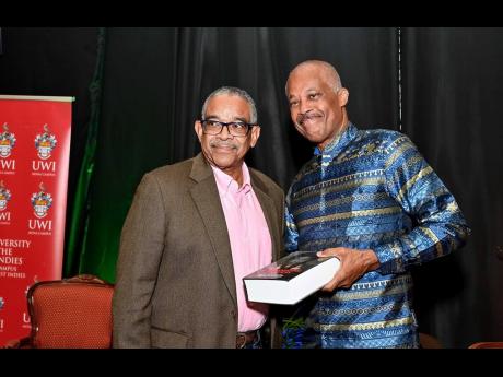Ian Randle (left), founder/chairman, Ian Randle Publishers, with  Professor Sir Hilary Beckles, Vice Chancellor of The University of the West Indies (UWI), following  the presentation of a copy of ‘Interrogating Justices’ to him at the Festschrift in h