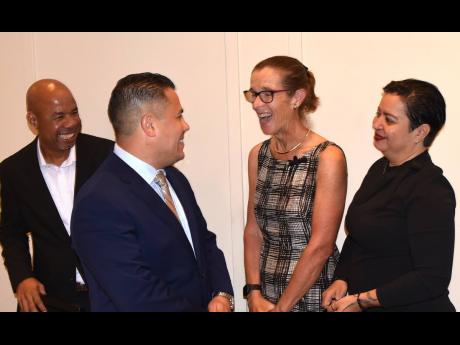 Minister without Portfolio in the Ministry of Economic Growth and Job Creation, Senator Matthew Samuda (second left), exchanges pleasantries with British High Commissioner to Jamaica, Judith Slater (second right), at the launch of the ‘Regional Climate F