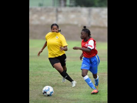 Shanhaine Nelson (left) from Cavalier Soccer Club and Jamie Roacho from Rangers FC battle for the ball during the JWPL semi-finals at the UWI-JFF Captain Horace Burrell Centre Of Excellence on April 22, 2023.