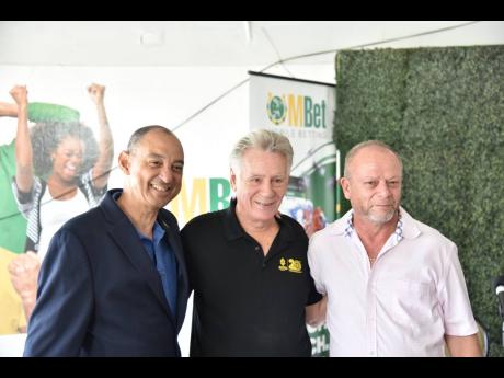 From left: Oakridge Farms and Atomica owner, Don Wehby, race announcer Brian Rickman, and Atomica trainer, Gary Subratie are all smiles at the 2023 Horse of the Year announcement at Caymanas Park yesterday. 