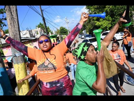Supporters of People’s National Party and Jamaica Labour Party celebrate on nomination day, February 8.
