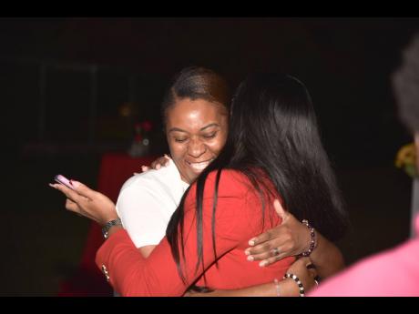 Overcome with gratitude and familiarity, Nastassia Hall-Lewis (left), a bride at the last 14-14-14, embraces the woman who gave her a fairytale concept, creator Monique Walcott.