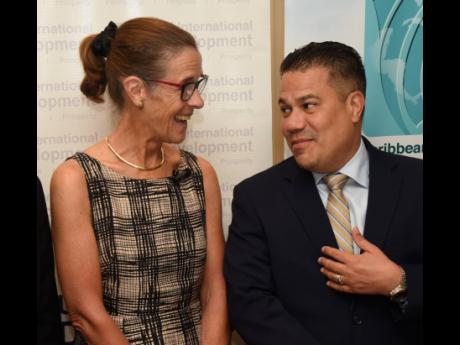 Senator Matthew Samuda (right), Minister in the Ministry of Economic Growth and Job Creation, talks climate change with Judith Slater (left), British High Commissioner to Jamaica during the launch of Small Island Developing States Capacity and Resilience (