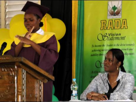 Kimberly Simpson addressing the graduation ceremony of the Caribbean Christian Centre for the Deaf’s Climate Smart Agriculture Greenhouse Production Training, held recently at the  Knockpatrick campus.