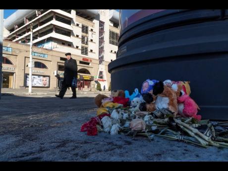 Flowers and toys lie on the ground at a makeshift memorial commemorating victims of a December 30 missile attack by Ukraine in Belgorod, Russia, which has come under repeated Ukrainian shelling, and hundreds of bus stops in the city near the border with Uk