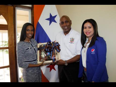 Anecia Levy (left), transformation manager at Pepsi, presents a token of appreciation to Ambassador Dr Lasford Douglas, the ambassador of Panama to Jamaica (center), alongside Bianca Fakhourie, corporate affairs and legal manager, Pepsi. The token was an e
