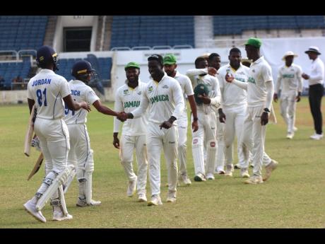 
Jamaica Scorpions and Barbados Pride shake hands at the end of their West Indies Championship game at Sabina Park yesterday.