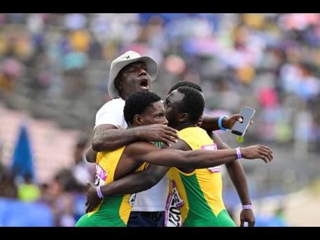 
Bert Cameron celebrates with St Jago’s Class 1 Boys team moments after they won the 4x100 metres at the Gibson McCook Relays held at the National Stadium yesterday.