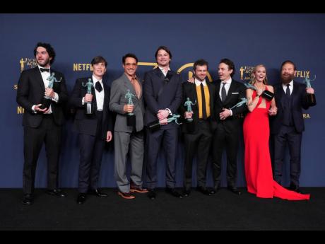 Benny Safdie, from left, Cillian Murphy, Robert Downey Jr., Josh Hartnett, Alden Ehrenreich, Casey Affleck, Emily Blunt, and Kenneth Branagh, winners of the award for the award for outstanding performance by a cast in a motion picture for ‘Oppenheimer’