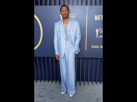 Tyler James Williams dons Amiri and patent loafters by Jimmy Choo.