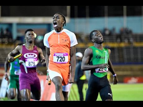 The final-leg runner from Flying Angels (720),  a Canada-based track club, crosses the line to win the  Boys’ Class One  4x200 metres final at last Saturday’s Gibson McCook Relays at the National Stadium..