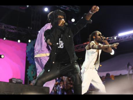 Cloaked in all black, Popcaan was almost unrecognisable, save for the word UNRULY emblazoned in large letters across his back and his trademark 876 GUD chain. 