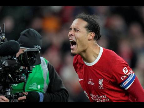 Liverpool’s Virgil van Dijk celebrates after scoring the winning goal in extra-time during the English League Cup final between Chelsea and Liverpool at Wembley Stadium in London yesterday.