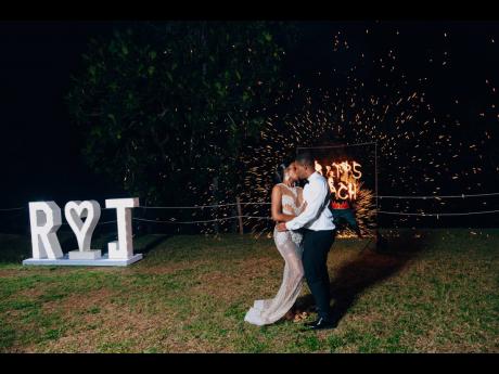 With both literal and metaphorical sparks flying, the bride and groom share a sensual kiss.
