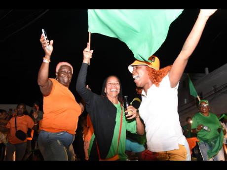 People’s National Party and Jamaica Labour Party supporters enjoying the festivities as they await the results for the local government elections along the Westgreen main road in Montego Bay, St James, on Monday.