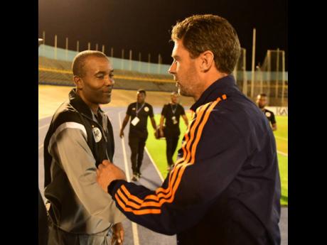 Head coach, Rudolph Speid (left), of Cavalier SC greets Patrick Noonan his counterpart at FC Cincinnati during their first-leg Champions Cup fixture at the National Stadium on Thursday.