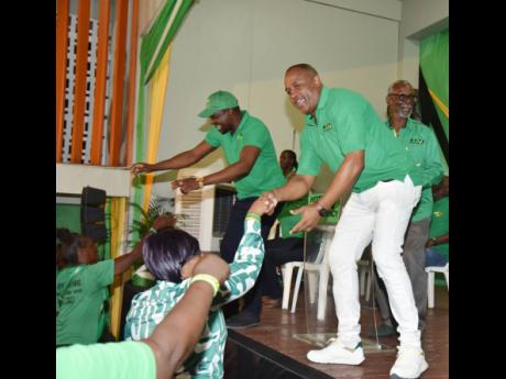 Former People’s National Party councillors Garfield James (left) and Ian Myles, who switched allegiance to the Jamaica Labour Party (JLP) last year, greet the audience at a political meeting last November. Myles and James are among the three JLP represen