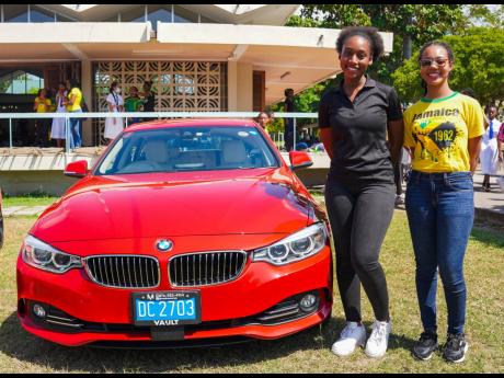 Students snap a quick photo beside this red ‘Bimma’ (BMW).