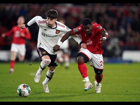 Manchester United’s Alejandro Garnacho and Nottingham Forest’s Serge Aurier battle for the ball during an English League Cup last year.