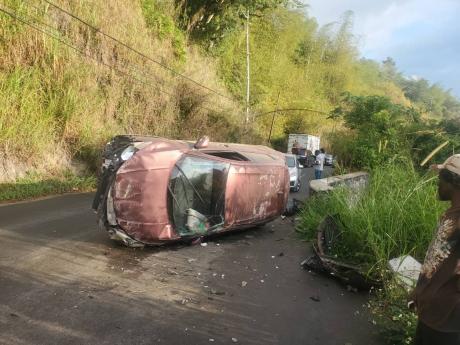 This overturned vehicle as involved in the second crash along the Temple Hall main road in St Andrew on Friday.