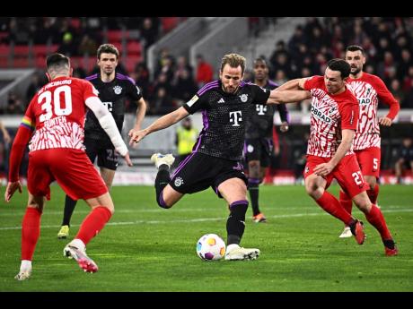 Bayern Munich’s Harry Kane (centre) prepares to take a shot during the Bundesliga match between SC Freiburg and Bayern Munich at the Europa-Park Stadium in Freiburg, Germany yesterday.