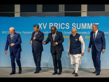 From left, Brazil’s President Luiz Inacio Lula da Silva, China’s President Xi Jinping, South Africa’s President Cyril Ramaphosa, India’s Prime Minister Narendra Modi and Russia’s Foreign Minister Sergei Lavrov pose for a BRICS group photo during 