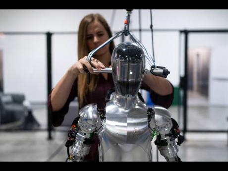 AI engineer Jenna Reher works on humanoid robot Figure 01 at Figure AI’s test facility in Sunnyvale, California, October 3, 2023.