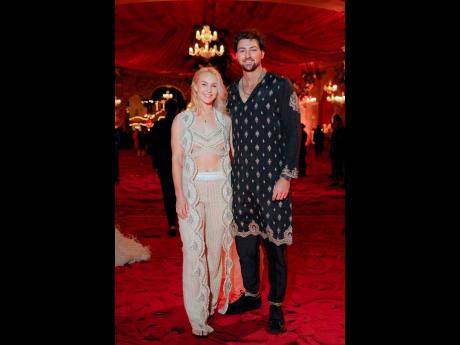 This photograph released by the Reliance group shows Australian cricketer Tim David and wife Stephanie Kershaw posing for a photograph.