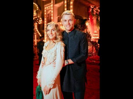 This photograph released by the Reliance group shows England cricketer Sam Curran and Isabella Grace posing for a photograph at a pre-wedding bash of billionaire industrialist Mukesh Ambani’s son, Anant Ambani.