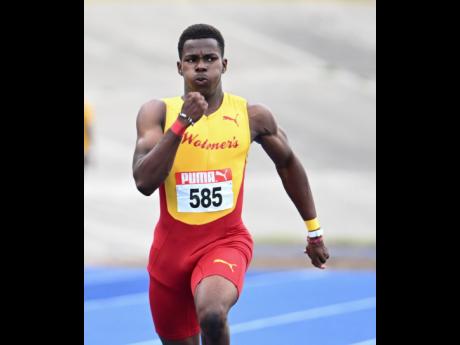 Gary Card of Wolmer’s Boys wins the under-20 boys’ 200 metres final at the Carifta Trials yesterday at the National Stadium.