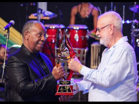  Harris 'BB' Seaton (left) accepts the JaRIA Honour Award from Joseph Matalon at a function held at the Courtleigh Auditorium in February 2015. 