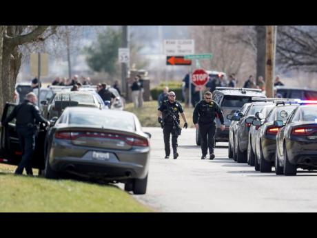Law-enforcement officials and medical personnel work the scene of an officer-involved shooting in Independence, Missouri. 