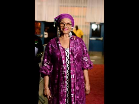 Marcia Griffiths looked regal in purple on the red carpet.