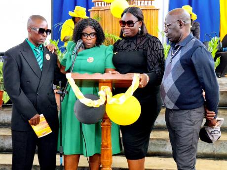 From left: Dennis Campbell, Tanya Allen-Campbell, Simone Samuels-Miller and O’Neil Allen’s father, Althi Alexander Allen paying tribute during the service of thanksgiving for accident victims Angella Samuels and son O’Neil Allen at the Footprints Sev