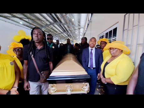 Pall-bearers carrying the caskets bearing the remains of Angella Samuels and her son, O’Neil Allen, from the Footprints Seventh-day Adventist Church in Westmoreland on Sunday.