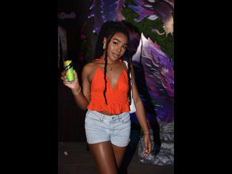 TikTok content creator Sage Dawson is pictured posing with a can of Rum Stripe, which recently announced a three-year partnership with GenXS Carnival.