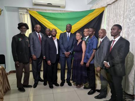 Peter Townsend (centre) surrounded by other members of the Jamaica Unity Alliance (JUA) at the launch of their merger at Medallian Hall Hotel in St Andrew on Wednesday. The JUA is a merger of four political parties – the National Democratic Movement, the