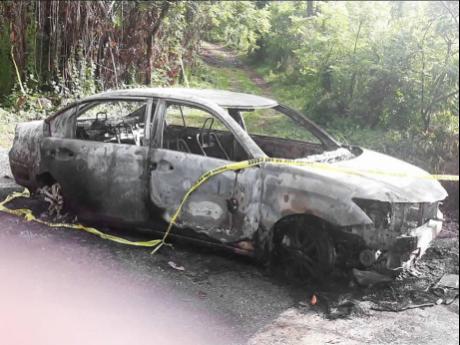 Remnants of the car at the scene where the burnt body of Tonia McDonald was found with her throat slashed in Sherwood Forest, Portland.