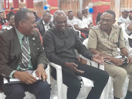 Dr Orville Taylor (centre) engages Dr Kevin Goulbourne (left), director of Mental Health and Substance Abuse Services at the Ministry of Health and Wellness, and Senior Superintendent Christopher Phillips, commander of the St Catherine South police divisio