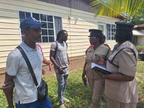 From left: David Black, father of Javian Black, is being engaged by Deputy Superintendent of Police Merna Ferguson-Campbell and head of the Community Safety and Security Branch in Westmoreland, Deputy Superintendent of Police Nadine Grant-Brown, after clea