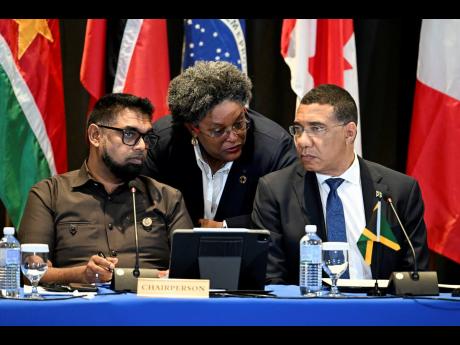 Mia Mottley (centre), Prime Minister of Barbados, in discussion with Dr Mohamed Irfaan Ali (left), chairman of CARICOM and president of Guyana, and Jamaica’s Prime Minister Andrew Holness at Monday’s high-level meeting of heads of government on the pol