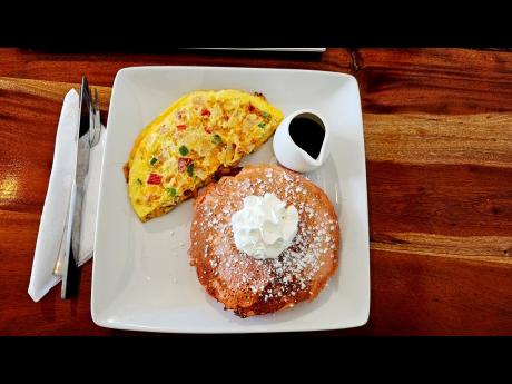 Breakfast lovers can indulge in the delights of this full-house omelette served with fluffy pancakes.