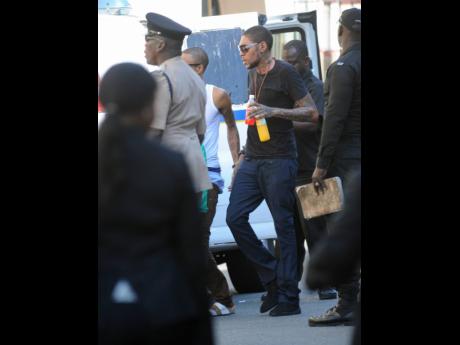 Adidja Palmer, more popularly know as Vybz Kartel, making his way into the Home Circuit Court for sentencing in 2014.