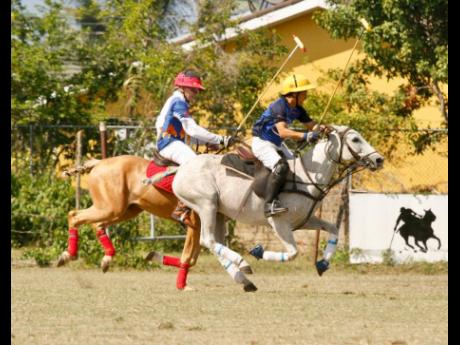West Indies Petroleum’s Mark Wates (left) chases ICWI’s Kurt Chin during the semi-finals of the Willie deLisser (Polo) Cup at the St Ann Polo Club in Drax Hall,  St Ann on Thursday.