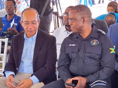 National Security Minister Dr Horace Chang listening attentively to incoming Police Commissioner Dr Kevin Blake at the groundbreaking ceremony for the construction of a new divisional headquarters for the Westmoreland Police Division on Friday at Llandilo 