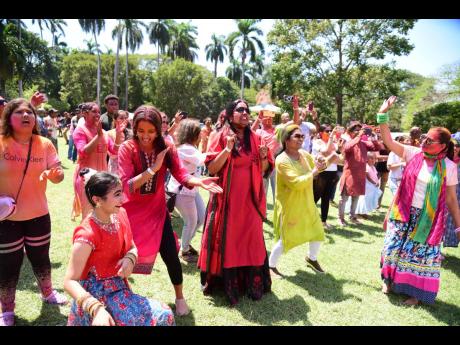Persons playing Holi, Hindu festival of colours ushering in Spring, at India-Jamaica Friendship Garden.