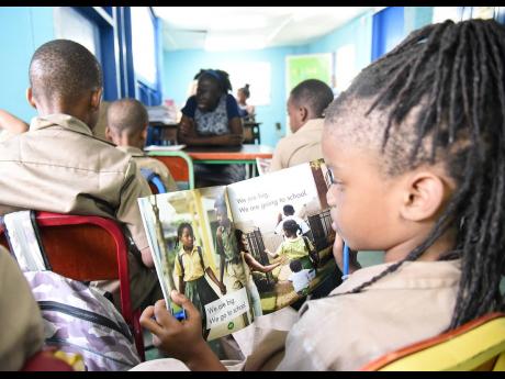 Students read during a ‘Drop everything and Read’ session at Grove Primary School in East Rural St Andrew. Don Robotham writes: There should be an increase in library teachers and the library service, whose sole task will be to support the work of the 