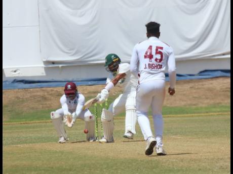 Photo by Lennox Aldred 
Jamaica Scorpions batman Brandon King (centre) bats against West Indies Academy bowler Joshua Bishop (right) during their West Indies Championship clash at Sabina Park yesterday. Academy wicketkeeper Carlon Bowen-Tuckett looks on.